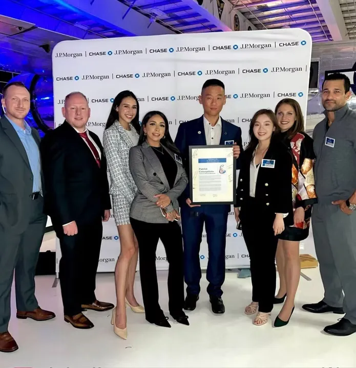 A smiling couple tenderly holding their newborn baby.