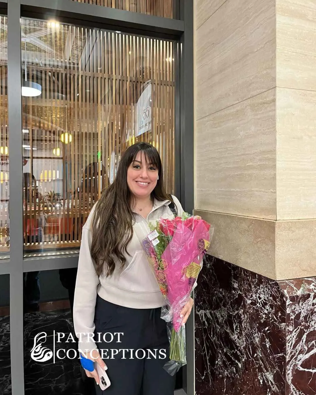 Patriot Conceptions surrogate holding flowers