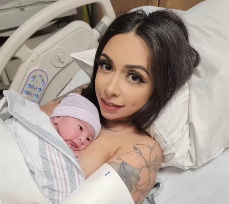 A newborn resting in the hospital on delivery day after a Patriot Conceptions journey