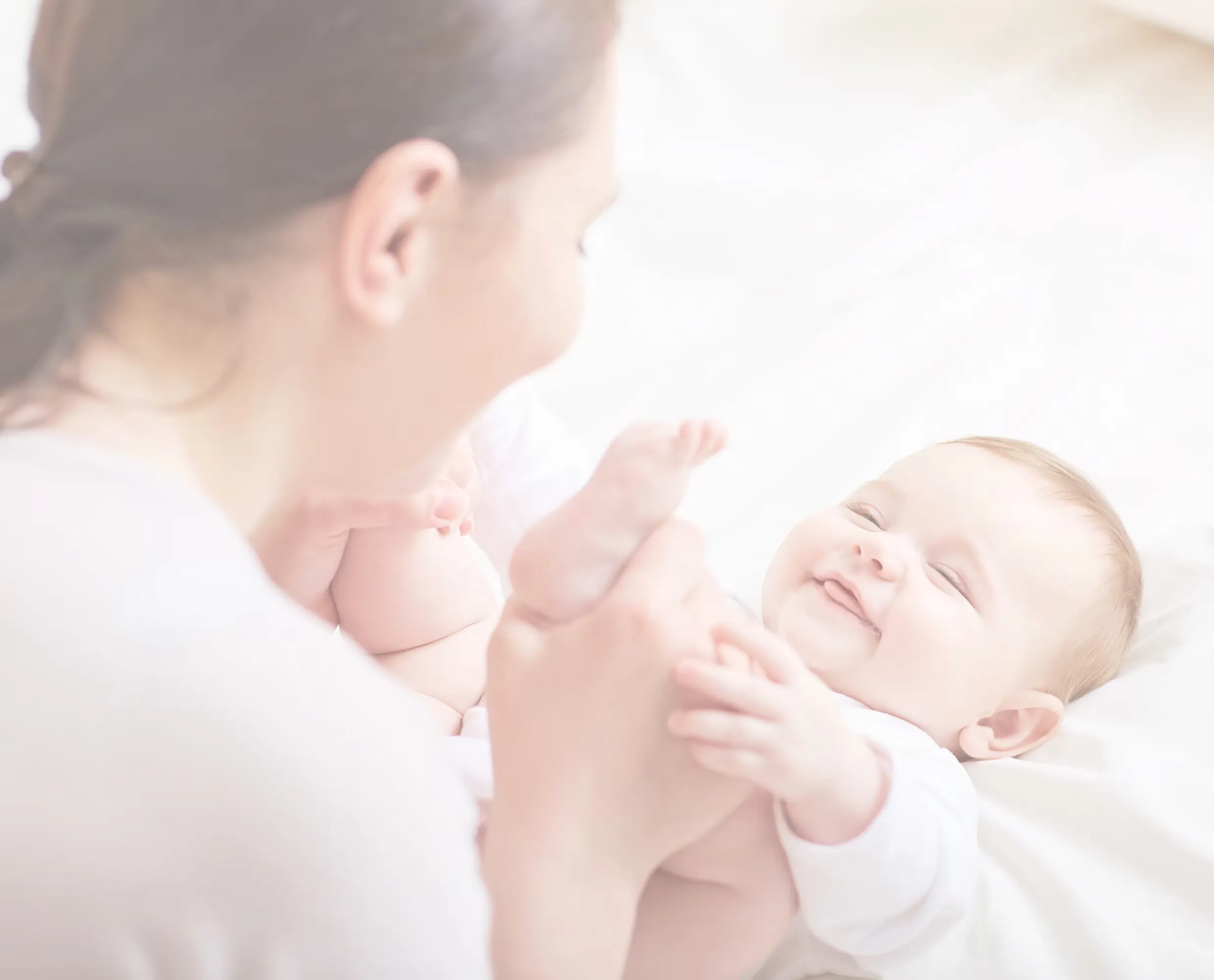 Parent holding a baby during a family-building milestone.