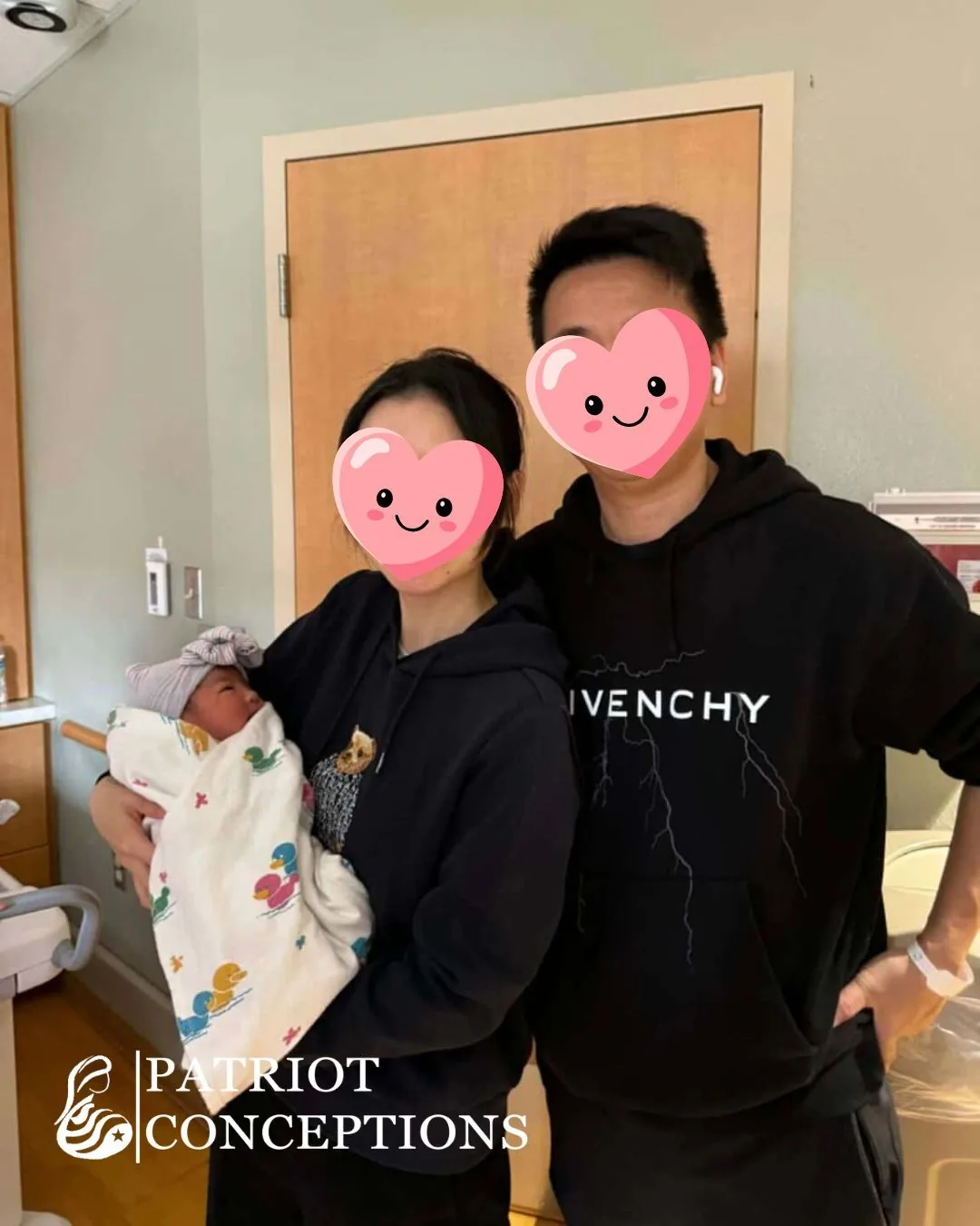 International intended parents holding their newborn in the hospital room after birth