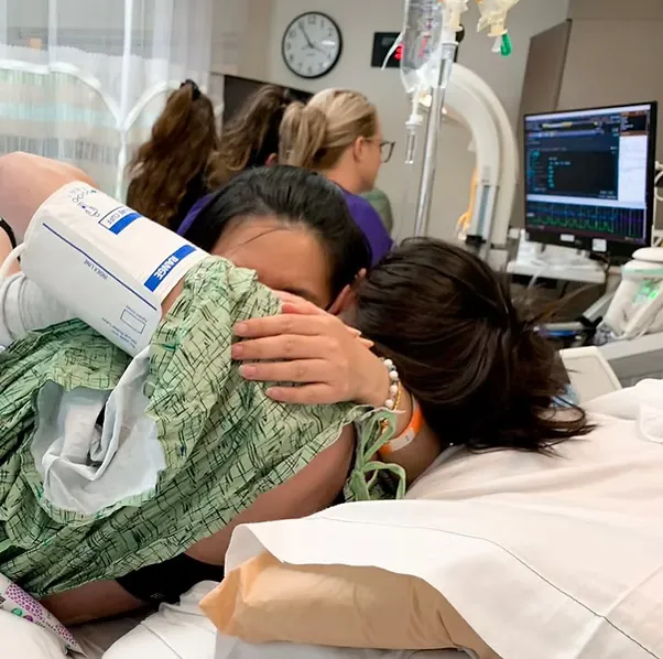 A loving couple of intended parents smiling warmly.