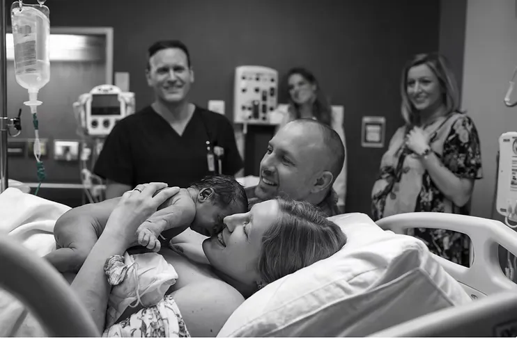 Family meeting their newborn in a hospital after a family-building journey.
