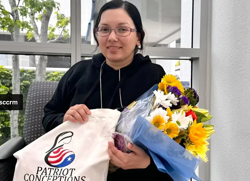 Happy egg donor with flowers